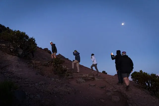 Two hikers + guide on a ridge trail